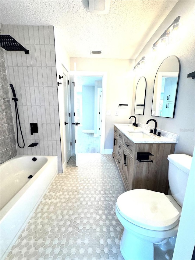 6524 Senegal Palm Way, Apollo Beach, FL 33572 - bathroom with toilet, baseboards,  shower combination, double vanity, and a textured ceiling