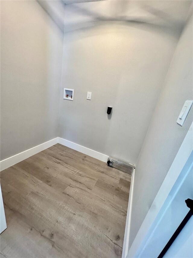 6524 Senegal Palm Way, Apollo Beach, FL 33572 - laundry area with hookup for a washing machine, wood finished floors, hookup for an electric dryer, and baseboards