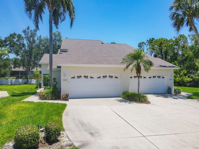 6222 Country Club Way, Sarasota, FL 34243 - view of front of property with stucco siding, concrete driveway, a garage, and a shingled roof