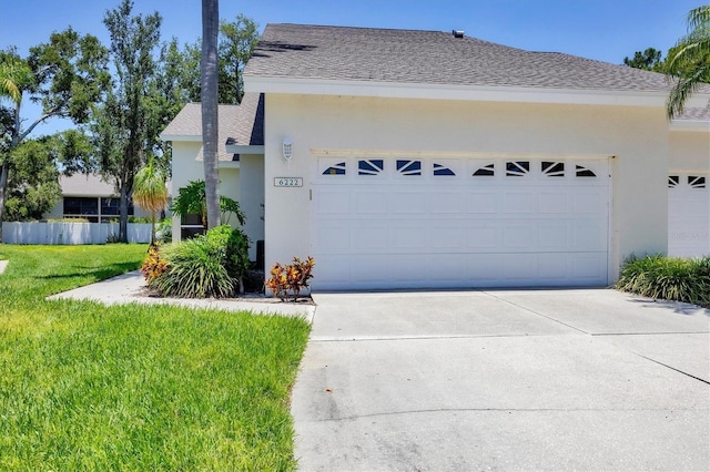 6222 Country Club Way, Sarasota, FL 34243 - view of side of home with stucco siding, a garage, concrete driveway, and roof with shingles