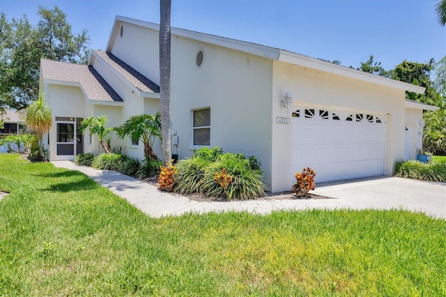 6222 Country Club Way, Sarasota, FL 34243 - view of front of home featuring an attached garage, stucco siding, a front lawn, and driveway