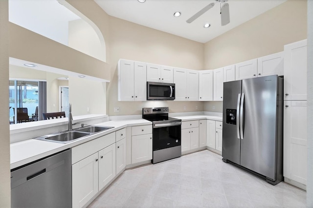 6222 Country Club Way, Sarasota, FL 34243 - kitchen featuring appliances with stainless steel finishes, a sink, ceiling fan, a towering ceiling, and light countertops