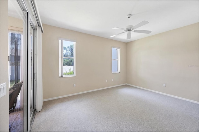 6222 Country Club Way, Sarasota, FL 34243 - unfurnished room with healthy amount of natural light, a ceiling fan, baseboards, and carpet floors