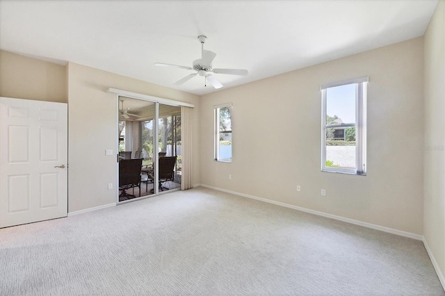 6222 Country Club Way, Sarasota, FL 34243 - unfurnished bedroom featuring access to exterior, multiple windows, carpet, and baseboards