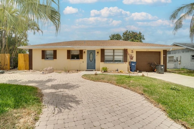 ranch-style home with decorative driveway, a garage, and stucco siding