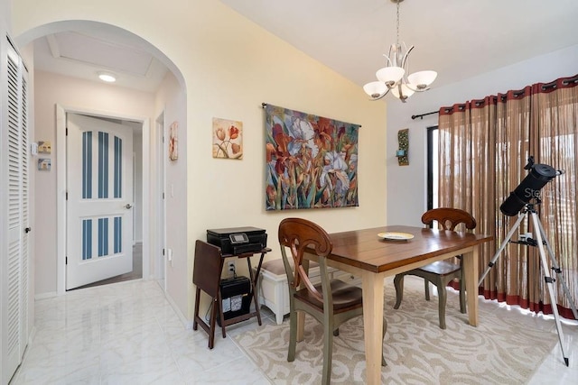 dining room featuring a chandelier, light marble finish flooring, arched walkways, and baseboards