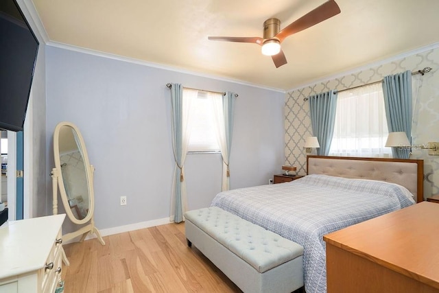 bedroom featuring crown molding, light wood finished floors, baseboards, and ceiling fan