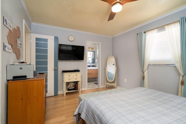 bedroom with multiple windows, light wood finished floors, crown molding, a ceiling fan, and connected bathroom