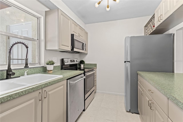 3212 Ramblewood Dr N Unit 3212, Sarasota, FL 34237 - kitchen featuring stainless steel appliances, a sink, light tile patterned flooring, light countertops, and baseboards