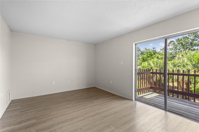 3212 Ramblewood Dr N Unit 3212, Sarasota, FL 34237 - empty room with wood finished floors and a textured ceiling
