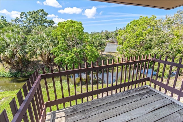 3212 Ramblewood Dr N Unit 3212, Sarasota, FL 34237 - wooden terrace with a water view and view of wooded area