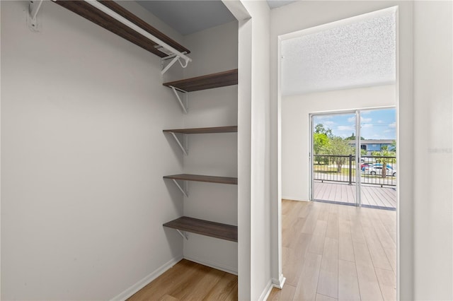 3212 Ramblewood Dr N Unit 3212, Sarasota, FL 34237 - walk in closet featuring light wood-style flooring