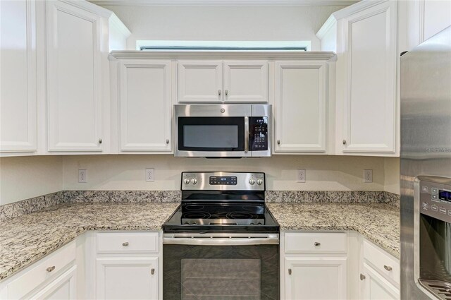24065 Canterwood Way, Venice, FL 34293 - kitchen with stainless steel appliances, white cabinets, and light stone counters