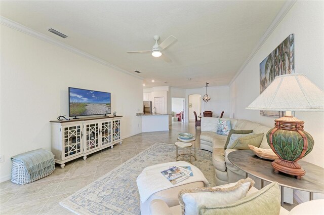 24065 Canterwood Way, Venice, FL 34293 - living area with ornamental molding, a ceiling fan, tile patterned flooring, and baseboards