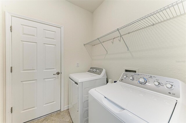 24065 Canterwood Way, Venice, FL 34293 - laundry area with washer and clothes dryer and light tile patterned floors