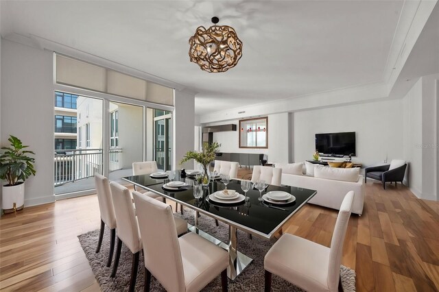 1350 Main St Unit 1703, Sarasota, FL 34236 - dining space with healthy amount of natural light, light wood-type flooring, and a chandelier