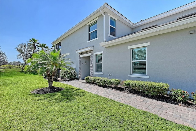 1017 Tidewater Shores Loop Unit 1017, Bradenton, FL 34208 - view of front of property featuring stucco siding and a front lawn