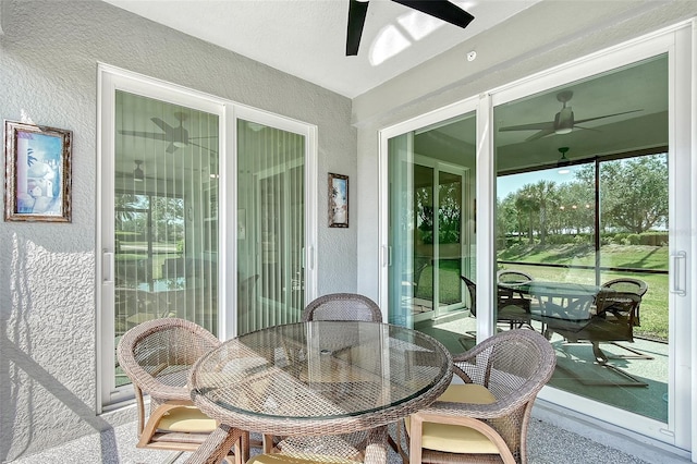 1017 Tidewater Shores Loop Unit 1017, Bradenton, FL 34208 - sunroom featuring ceiling fan, a textured wall, and outdoor dining area