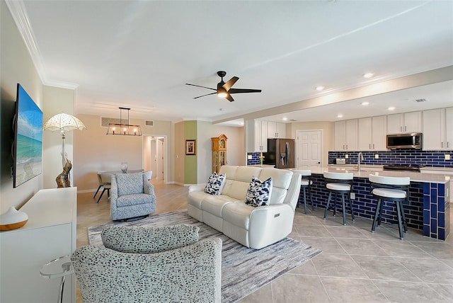 1017 Tidewater Shores Loop Unit 1017, Bradenton, FL 34208 - living room featuring light tile patterned floors, crown molding, and ceiling fan