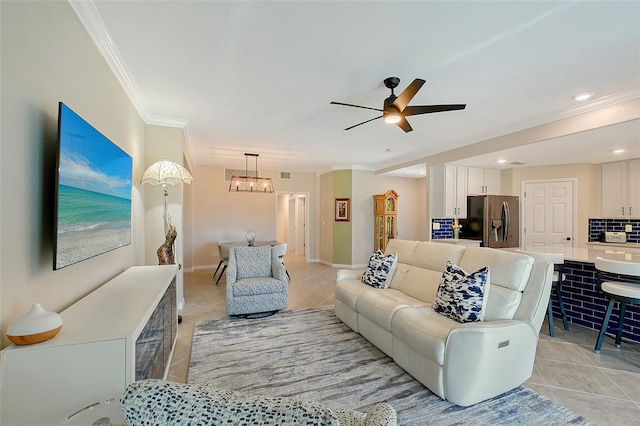 1017 Tidewater Shores Loop Unit 1017, Bradenton, FL 34208 - living room featuring light tile patterned floors, crown molding, a ceiling fan, a chandelier, and baseboards