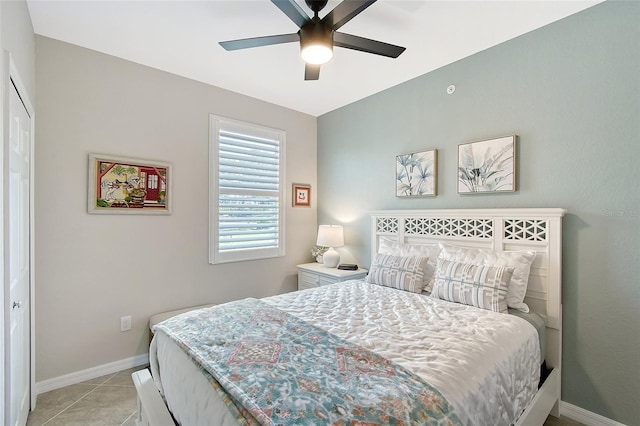 1017 Tidewater Shores Loop Unit 1017, Bradenton, FL 34208 - bedroom with baseboards, light tile patterned floors, and a ceiling fan