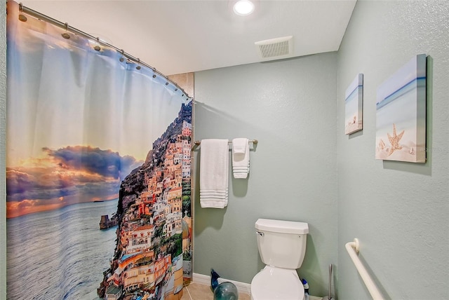 1017 Tidewater Shores Loop Unit 1017, Bradenton, FL 34208 - full bathroom featuring toilet, baseboards, and curtained shower