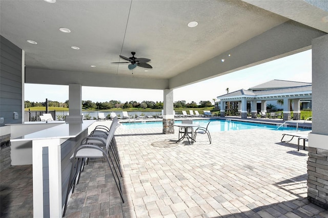 1017 Tidewater Shores Loop Unit 1017, Bradenton, FL 34208 - community pool with a pergola, a patio, fence, and ceiling fan