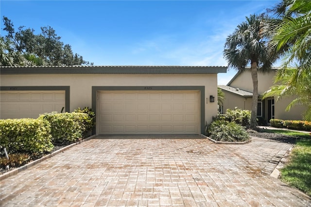 8525 54th Avenue Cir E, Bradenton, FL 34211 - view of front of home with decorative driveway, stucco siding, and a garage