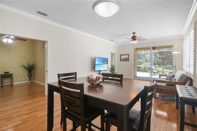 8525 54th Avenue Cir E, Bradenton, FL 34211 - dining room with ceiling fan, crown molding, light wood-type flooring, baseboards, and a textured ceiling