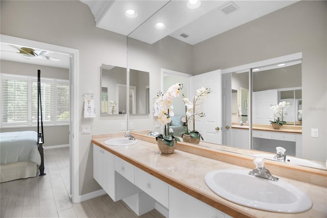8525 54th Avenue Cir E, Bradenton, FL 34211 - ensuite bathroom featuring baseboards, double vanity, recessed lighting, and wood finished floors