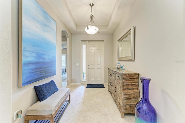 518 Chantilly Trl, Bradenton, FL 34212 - entryway featuring arched walkways, a raised ceiling, and light tile patterned flooring