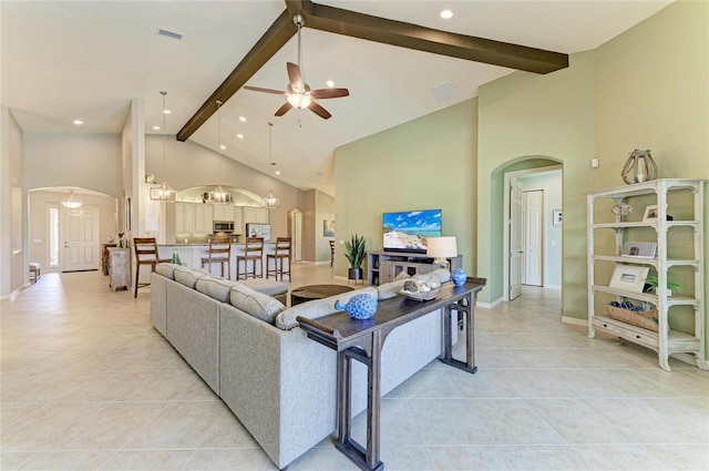 518 Chantilly Trl, Bradenton, FL 34212 - living area with arched walkways, beamed ceiling, light tile patterned floors, a ceiling fan, and high vaulted ceiling