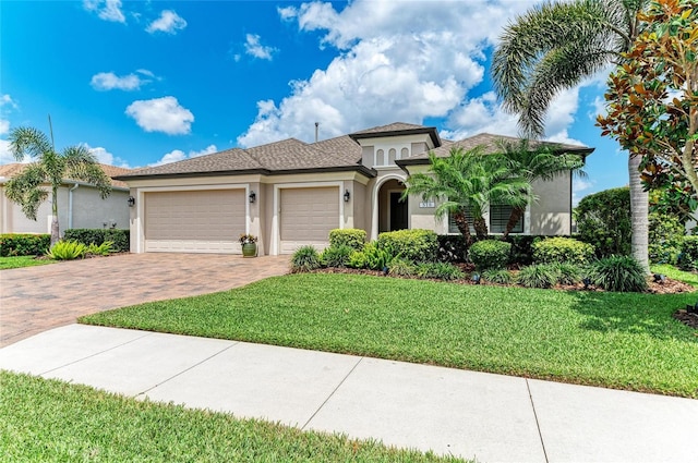 518 Chantilly Trl, Bradenton, FL 34212 - mediterranean / spanish house featuring stucco siding, decorative driveway, an attached garage, and a front lawn