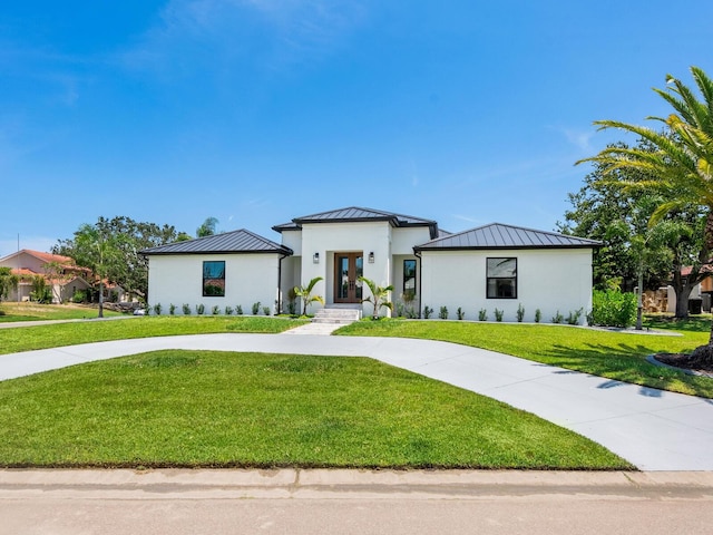 180 Lookout Point Dr, Osprey, FL 34229 - view of front of house featuring a standing seam roof, french doors, and a metal roof