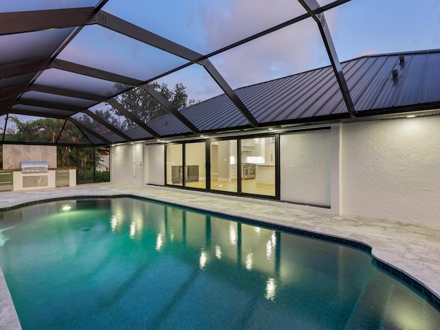 180 Lookout Point Dr, Osprey, FL 34229 - outdoor pool with an outdoor kitchen, a patio, and glass enclosure