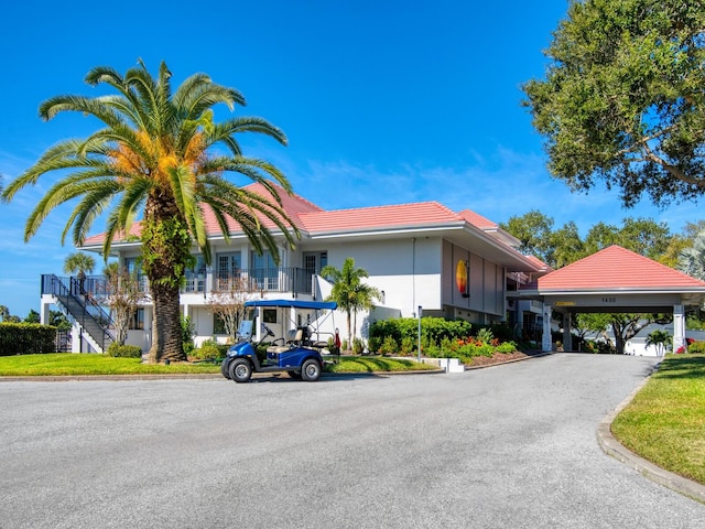 180 Lookout Point Dr, Osprey, FL 34229 - view of front facade with a tiled roof and stairs