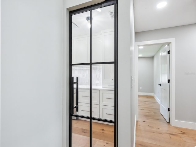 180 Lookout Point Dr, Osprey, FL 34229 - hallway featuring light wood finished floors and recessed lighting