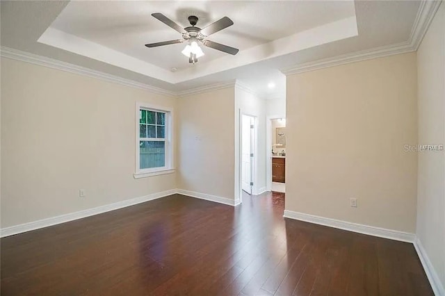 1420 E Frierson Ave, Tampa, FL 33603 - empty room featuring a raised ceiling, dark wood-style flooring, ceiling fan, and baseboards