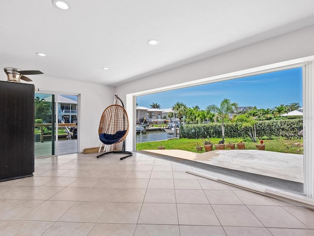 7779 Holiday Dr N, Sarasota, FL 34231 - unfurnished room with a water view, recessed lighting, tile patterned floors, and a ceiling fan