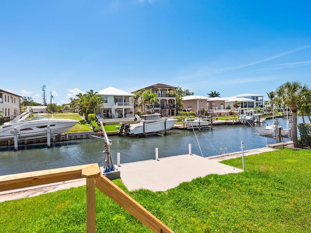 7779 Holiday Dr N, Sarasota, FL 34231 - dock with a water view and a lawn
