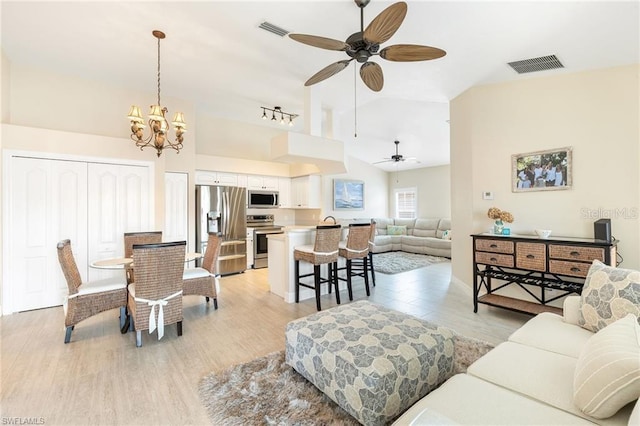 10202 L Pavia Blvd Unit 10202, Venice, FL 34292 - living room featuring light wood-style floors, ceiling fan, a chandelier, and high vaulted ceiling