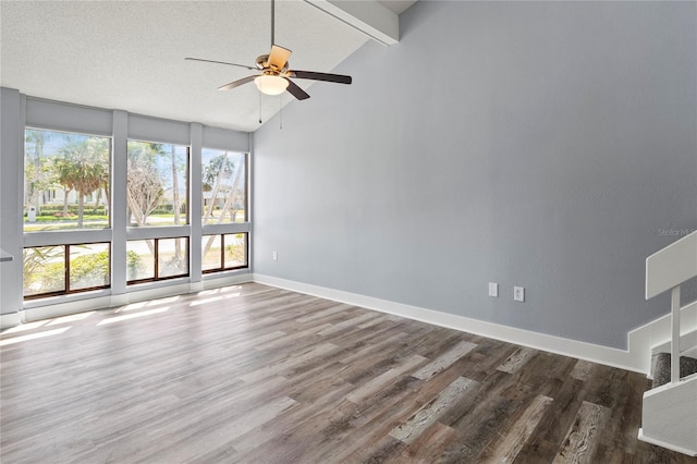 800 S Blvd Of The Presidents Unit 5, Sarasota, FL 34236 - empty room featuring wood finished floors, ceiling fan, beam ceiling, baseboards, and high vaulted ceiling