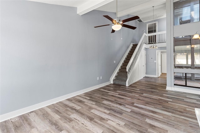 800 S Blvd Of The Presidents Unit 5, Sarasota, FL 34236 - unfurnished living room featuring wood finished floors, stairs, ceiling fan, beam ceiling, and baseboards