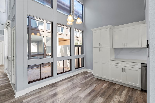 800 S Blvd Of The Presidents Unit 5, Sarasota, FL 34236 - unfurnished dining area with dark wood-style floors, plenty of natural light, and baseboards