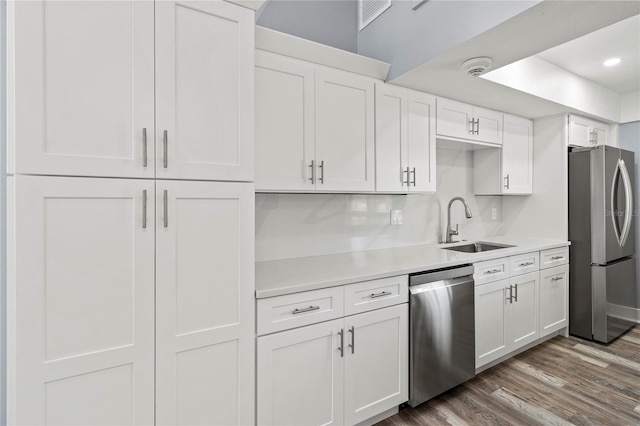800 S Blvd Of The Presidents Unit 5, Sarasota, FL 34236 - kitchen with appliances with stainless steel finishes, a sink, light countertops, white cabinetry, and wood finished floors