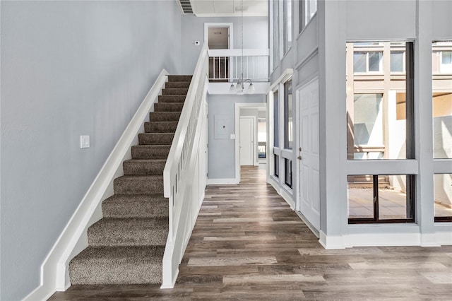800 S Blvd Of The Presidents Unit 5, Sarasota, FL 34236 - entryway featuring a towering ceiling, stairway, wood finished floors, and baseboards