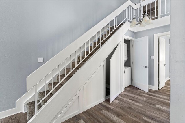800 S Blvd Of The Presidents Unit 5, Sarasota, FL 34236 - staircase featuring a chandelier, wood finished floors, and baseboards