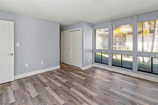 800 S Blvd Of The Presidents Unit 5, Sarasota, FL 34236 - unfurnished bedroom with wood finished floors and baseboards