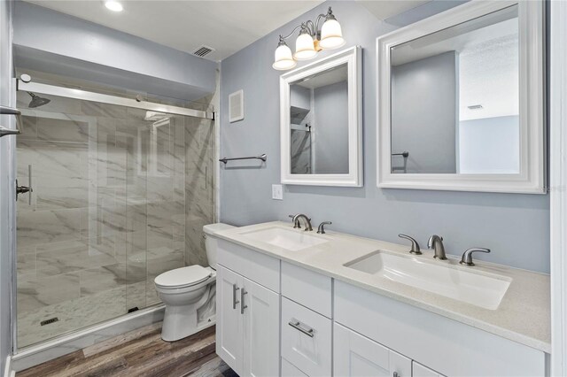 800 S Blvd Of The Presidents Unit 5, Sarasota, FL 34236 - full bath with toilet, a stall shower, double vanity, and wood finished floors