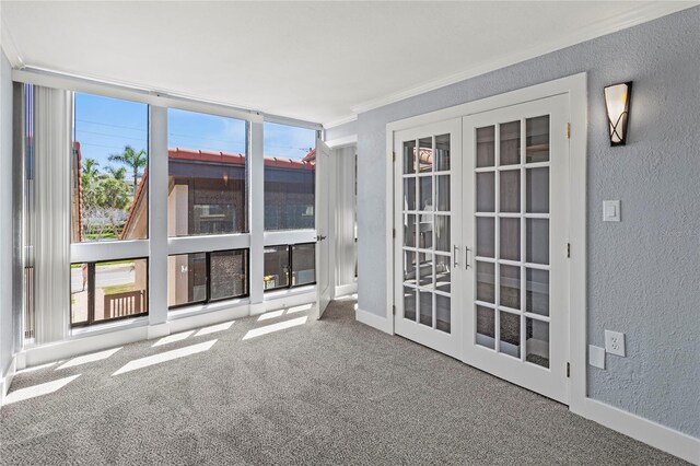 800 S Blvd Of The Presidents Unit 5, Sarasota, FL 34236 - carpeted spare room featuring a textured wall, french doors, ornamental molding, and baseboards
